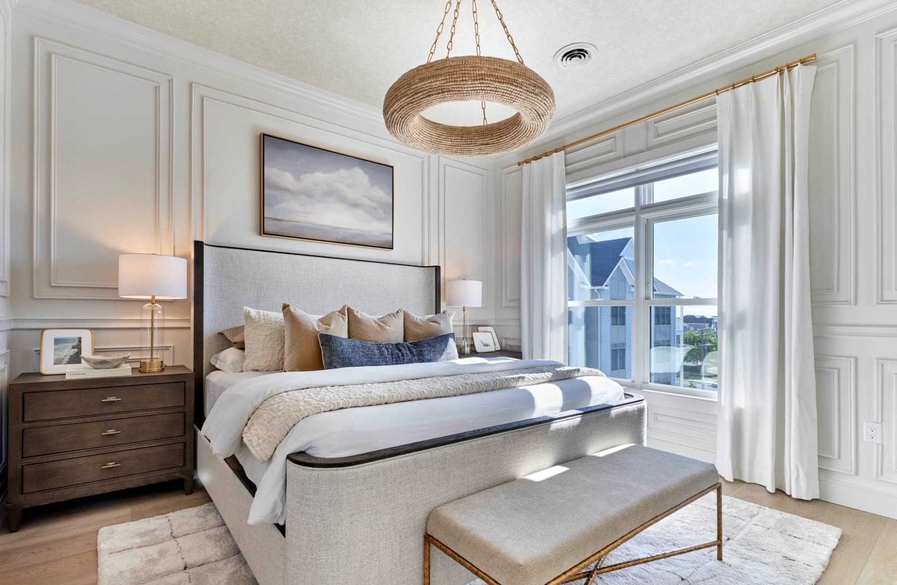 Liora residence bedroom with large windows and coastal-inspired finishes