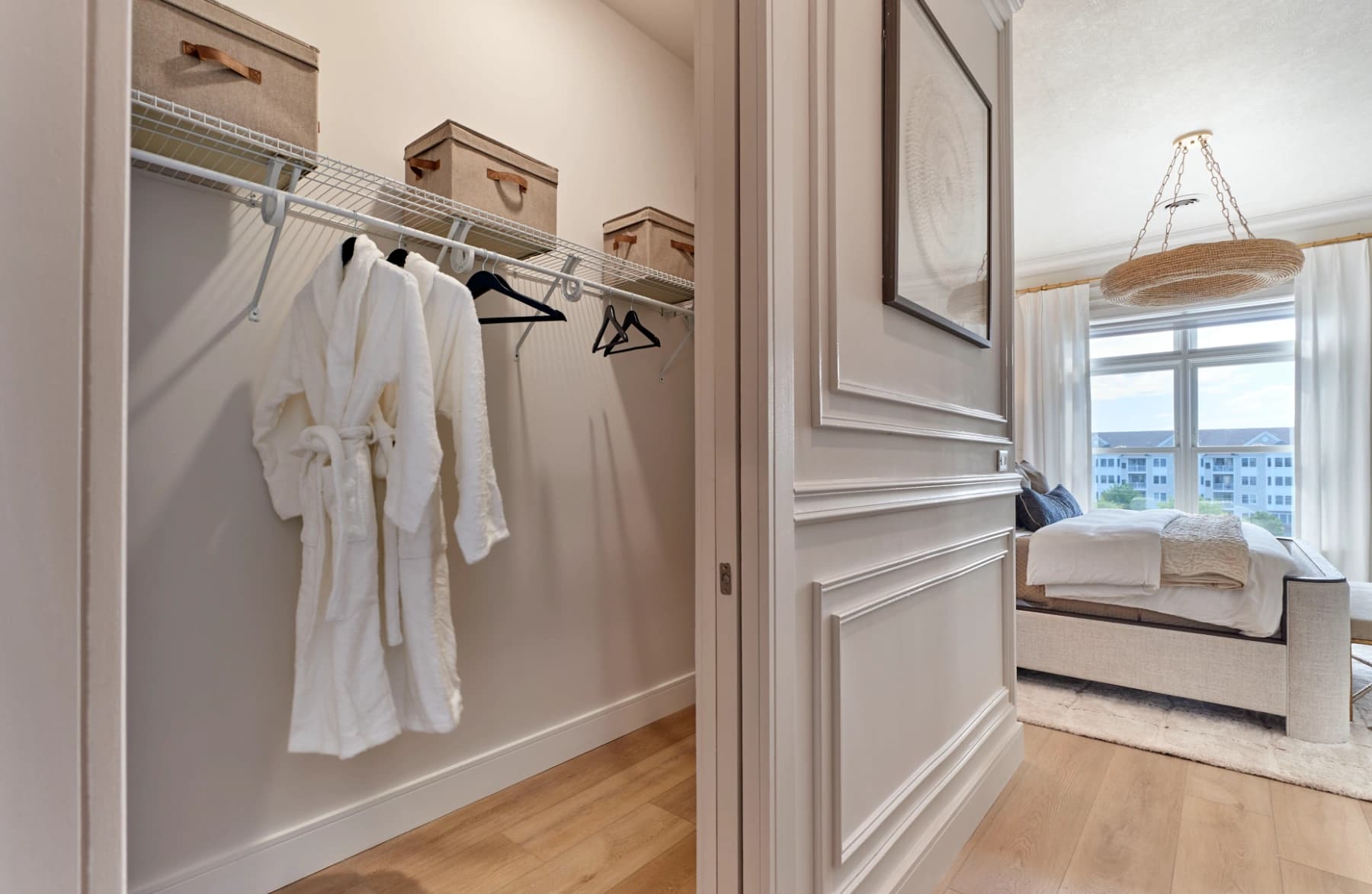 Liora residence bedroom closet with robes and storage shelves
