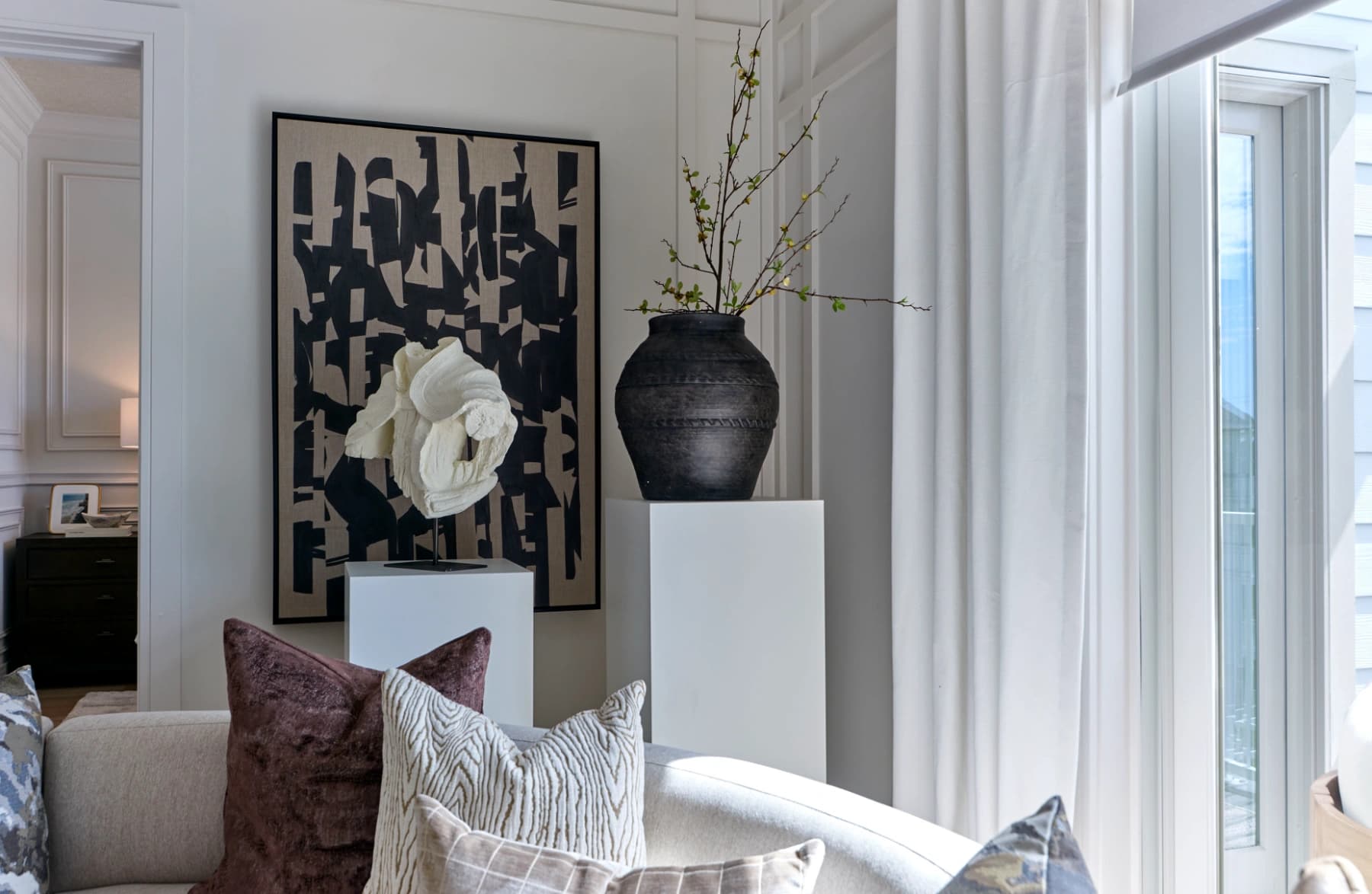 Liora residence living room detail with artwork and balcony doors